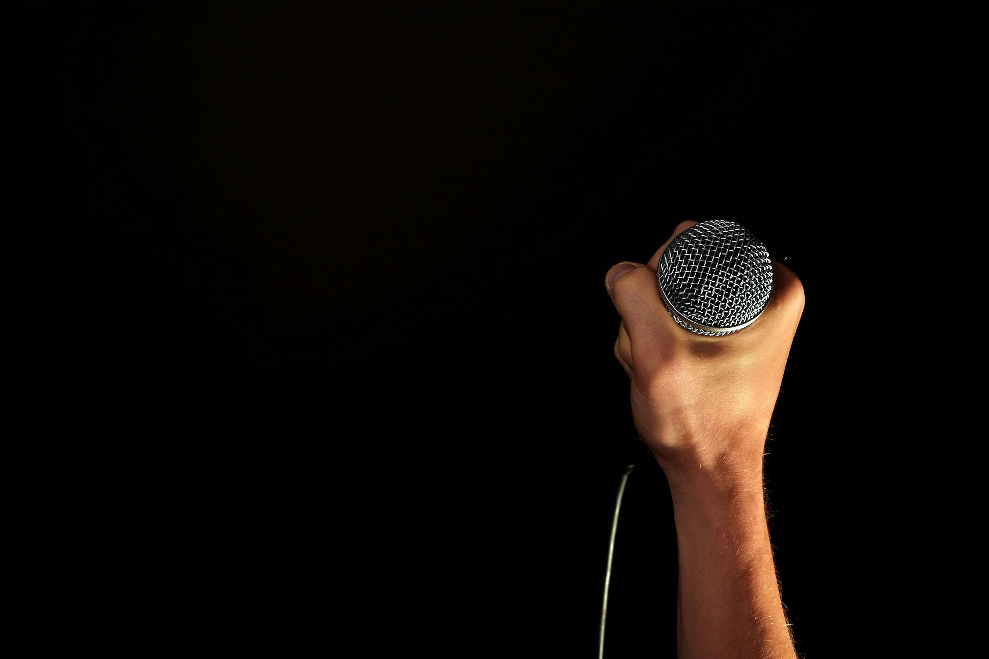 comedian holding microphone